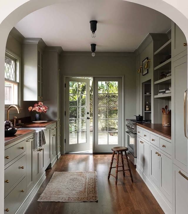 11. Soft Olive Galley Kitchen with Warm Wood Countertops - galley kitchen ideas