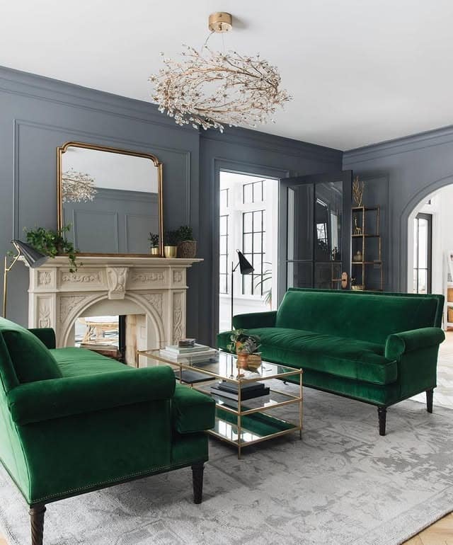 1. Classic Emerald Velvet Seating with Charcoal Panel Walls - emerald green living room ideas