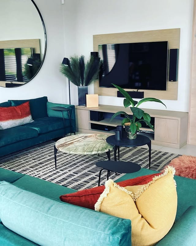 5. Casual Emerald Seating with Mixed Textures - emerald green living room ideas