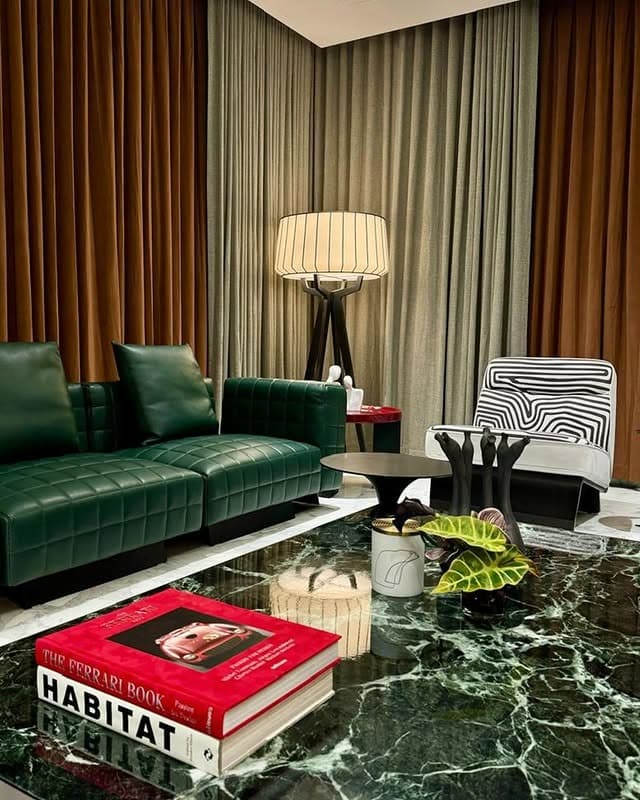 10. Emerald Leather Sofa with Contemporary Styling - emerald green living room ideas