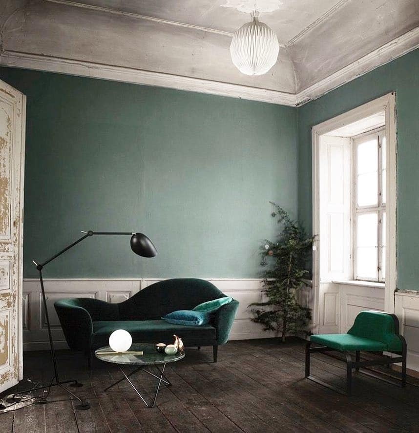 13. Vintage Emerald Walls with Classic Architectural Details - emerald green living room ideas