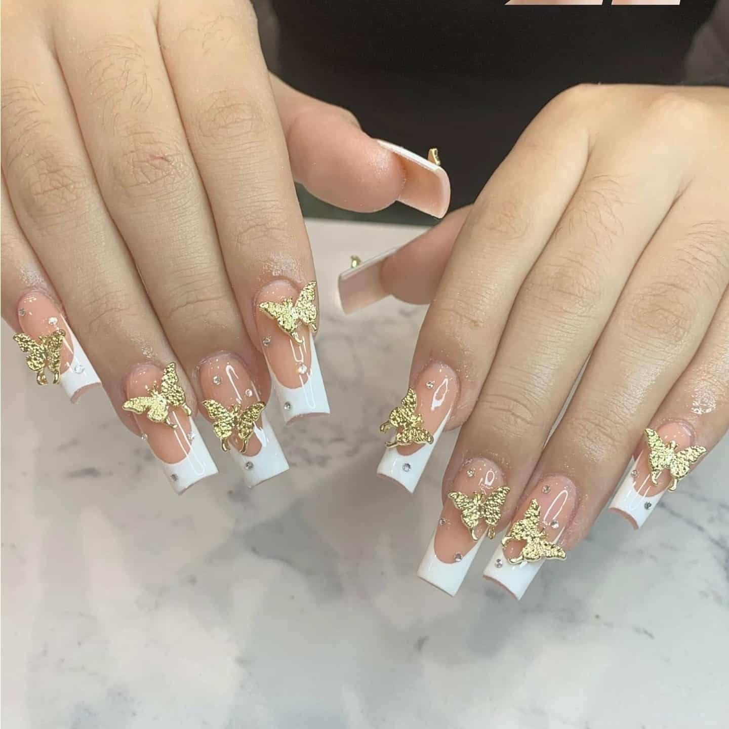 6. White French Tips with Gold Butterfly Charms - french tip nail ideas