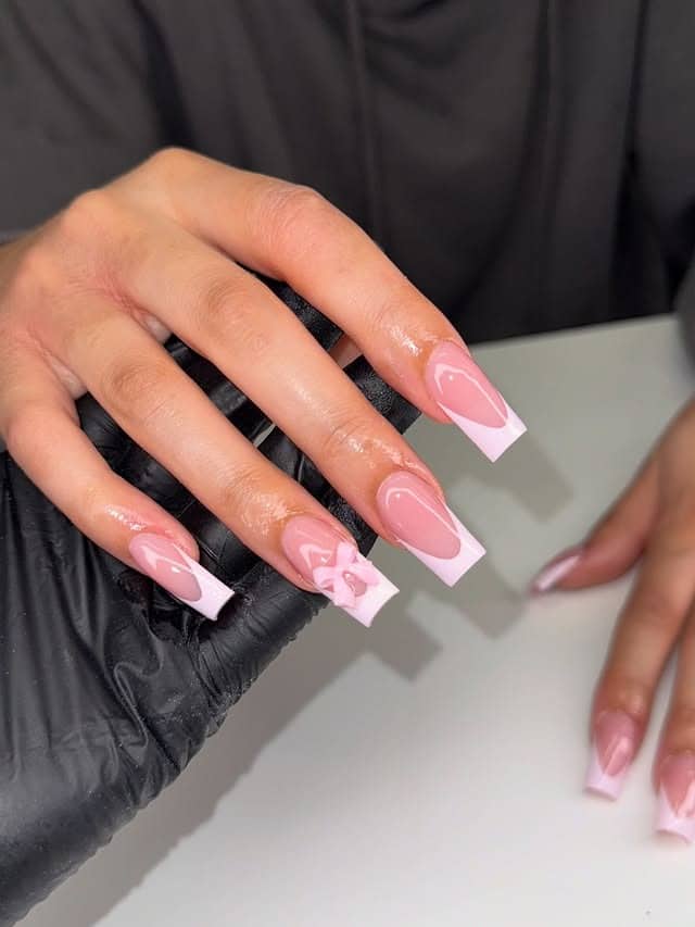 15. Glossy Pink Square French with Bow Accent - french tip nail ideas