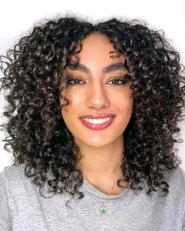 9. Defined Medium-Length Spiral Curls - Messy Curly Hair