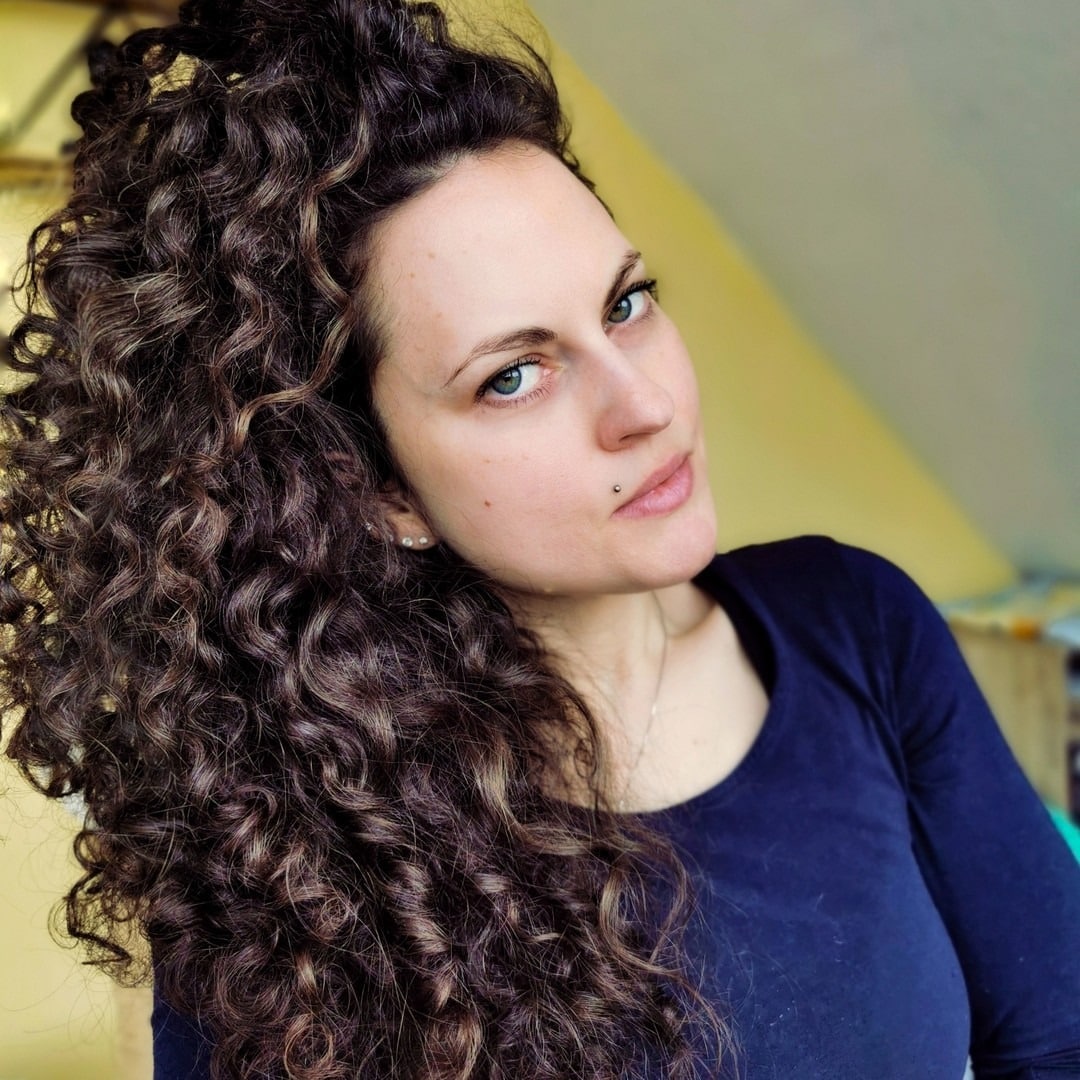 10. Long Brunette Curls with Subtle Highlights - Messy Curly Hair