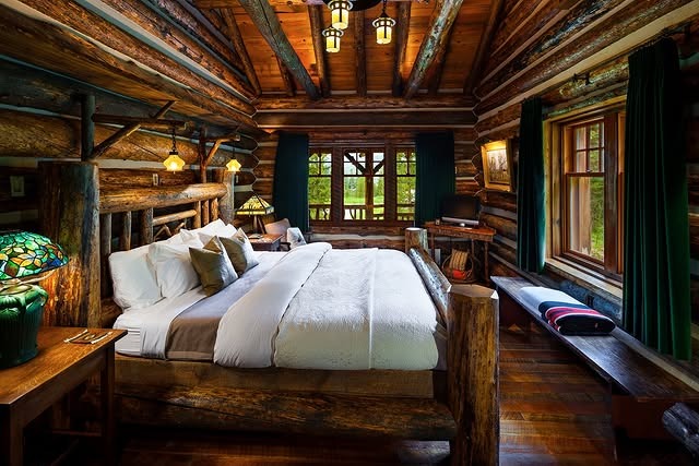3. Log Cabin Bedroom with Natural Timber Frame - rustic bedroom ideas