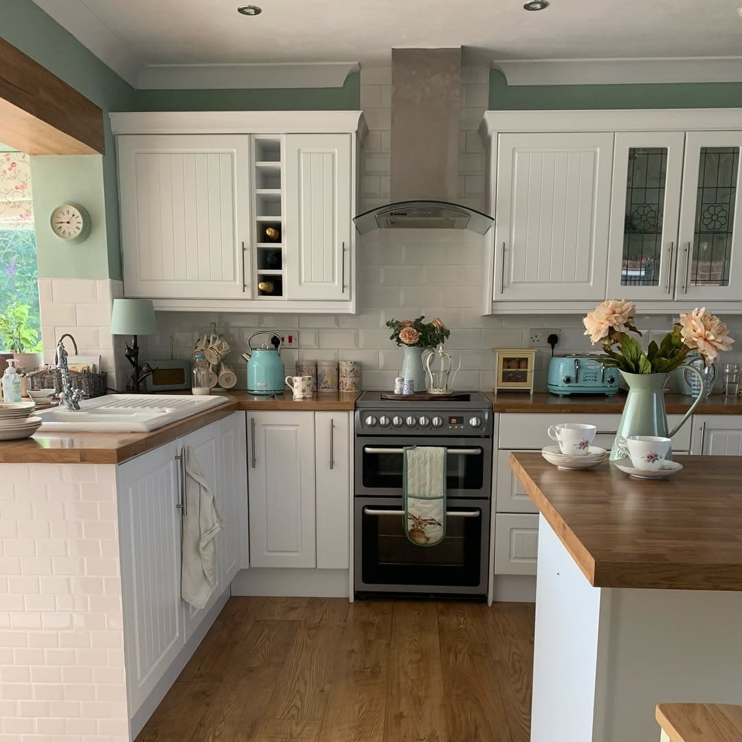1. Soft Sage Country Kitchen with Warm Wood Accents - country style kitchen ideas