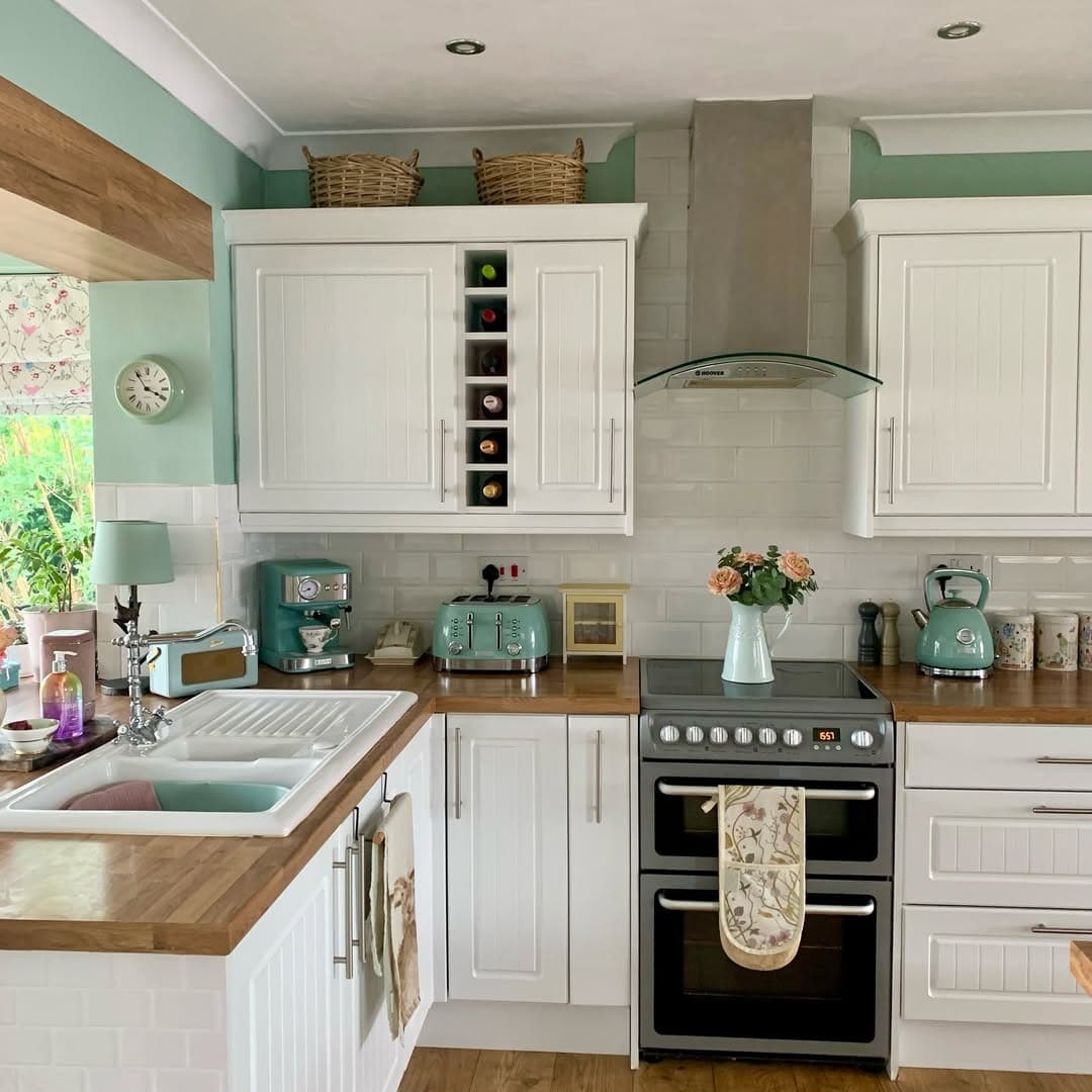 5. Classic White Country Kitchen with Pastel Accents - country style kitchen ideas