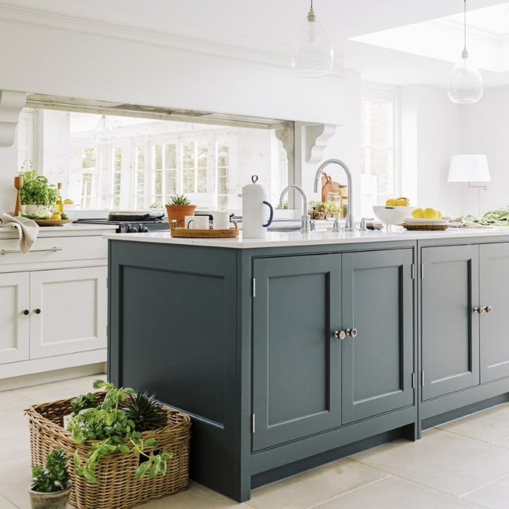 6. Light-Filled Country Kitchen with Blue-Grey Island and Natural Textures - country style kitchen ideas