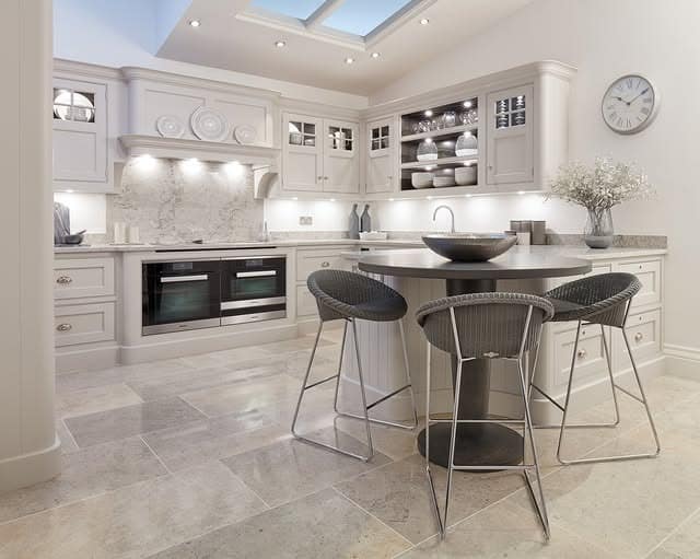 7. Refined Neutral Country Kitchen with Stone Flooring and Curved Details - country style kitchen ideas
