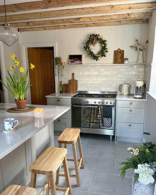 13. Light Grey Country Kitchen with Wooden Beams and Fresh Floral Accents - country style kitchen ideas