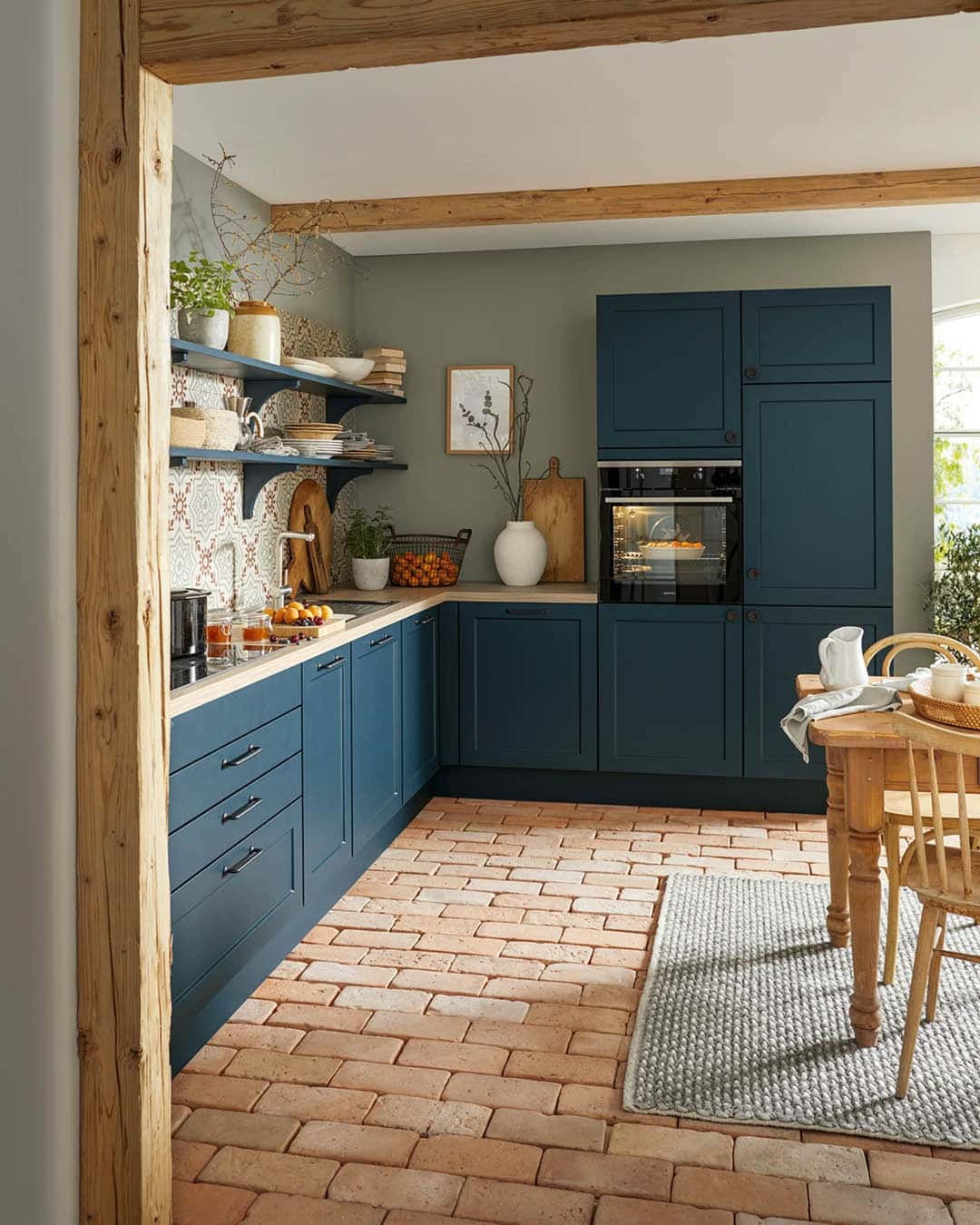 15. Deep Teal Country Kitchen with Brick Flooring and Patterned Backsplash - country style kitchen ideas