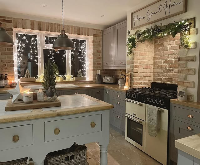18. Cozy Grey Country Kitchen with Brick Backsplash and Warm Lighting - country style kitchen ideas