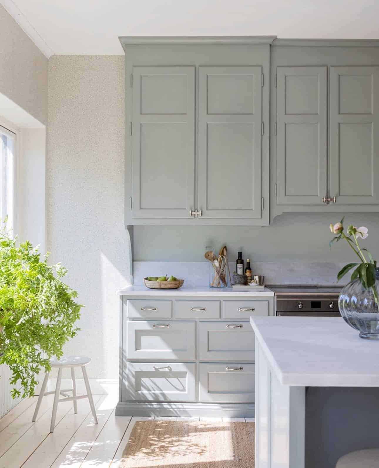 20. Minimal Country Kitchen with Soft Grey Cabinetry and Light Flooring - country style kitchen ideas