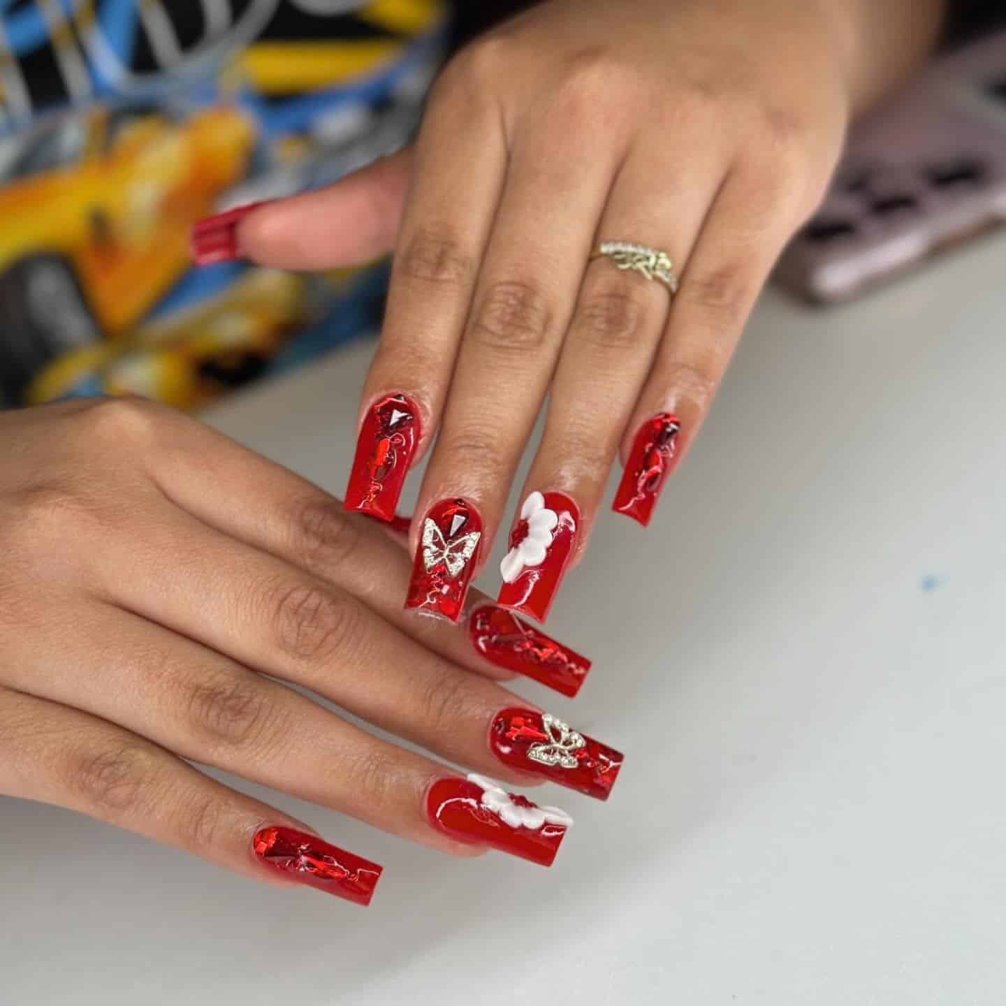 1. Glossy Red Coffin Nails with 3D Floral Accent - red prom nail ideas