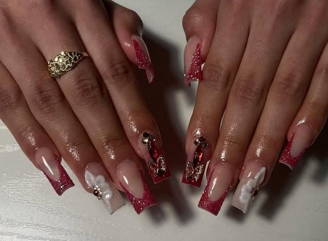 5. Glitter Red French Tip Coffin Nails with Crystal Accents - red prom nail ideas