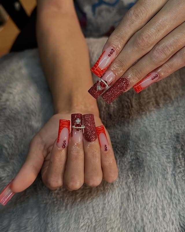 7. Red Glitter and Nude Coffin Nails with Accent Charm - red prom nail ideas