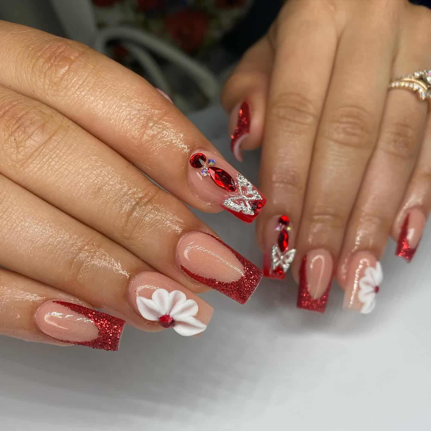 11. Red Glitter French Tip Coffin Nails with 3D Flower and Crystal Accents - red prom nail ideas