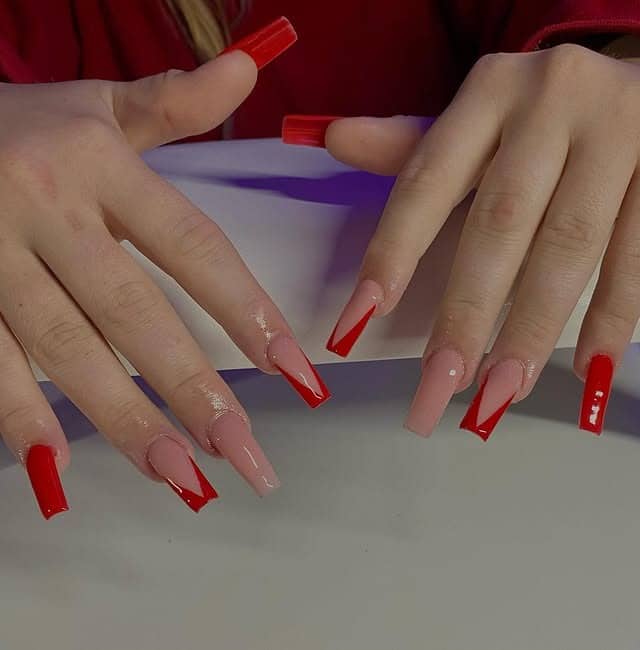 12. Sharp Red V French Tip Coffin Nails on Nude Base - red prom nail ideas