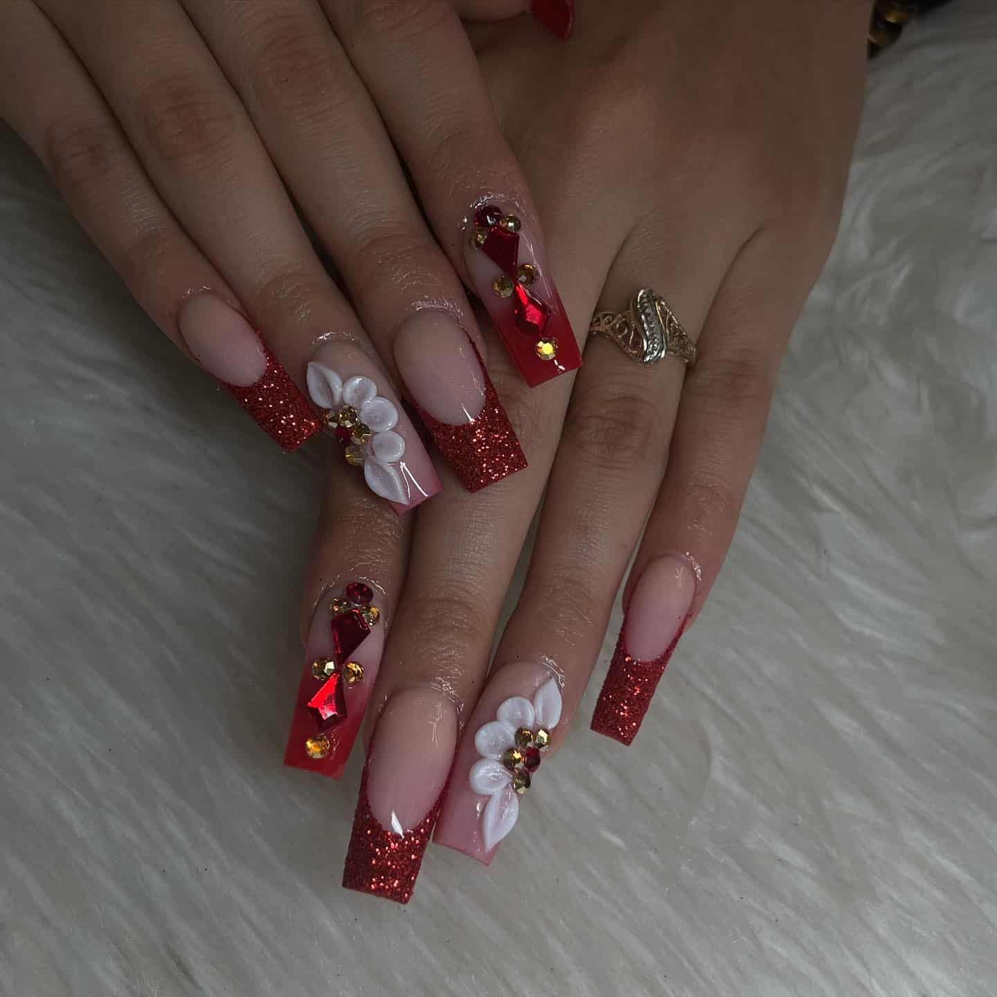 16. Red Glitter French Coffin Nails with White Floral Accents and Gems - red prom nail ideas