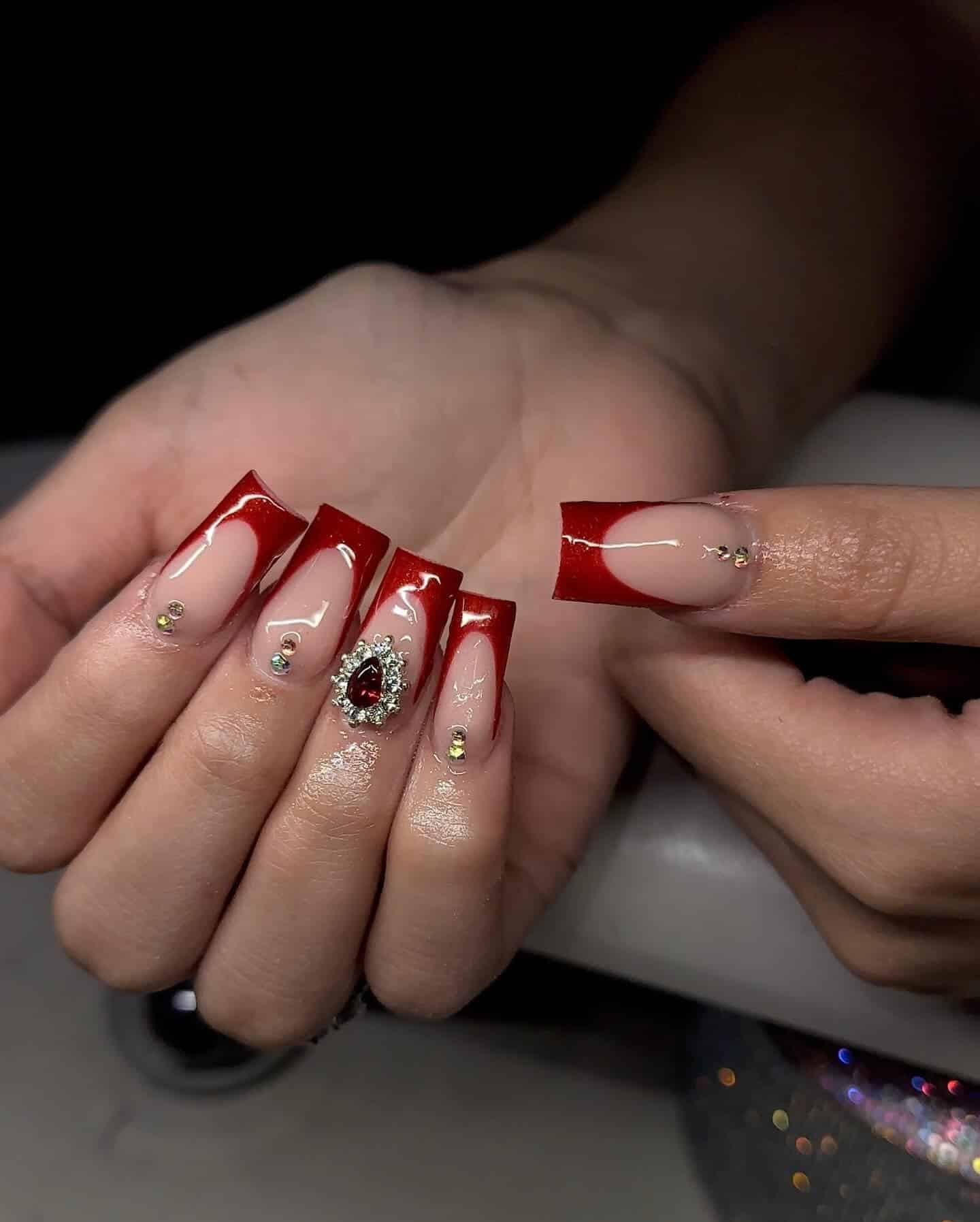 19. Glossy Red French Tip Coffin Nails with Minimal Rhinestone Detail - red prom nail ideas