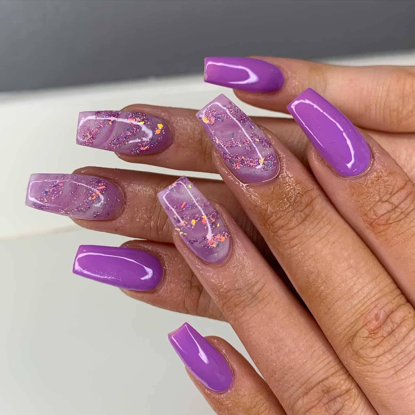 5. Glossy Purple Acrylic Nails with Glitter Encapsulation - purple and lavender nail ideas