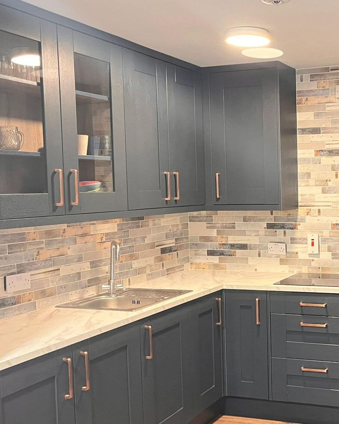 3. Mixed Neutral Linear Mosaic Tile with Charcoal Cabinets - kitchen tile ideas