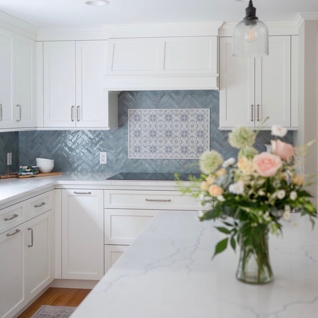 18. Soft Blue Herringbone Tile with Decorative Inset Panel - kitchen tile ideas