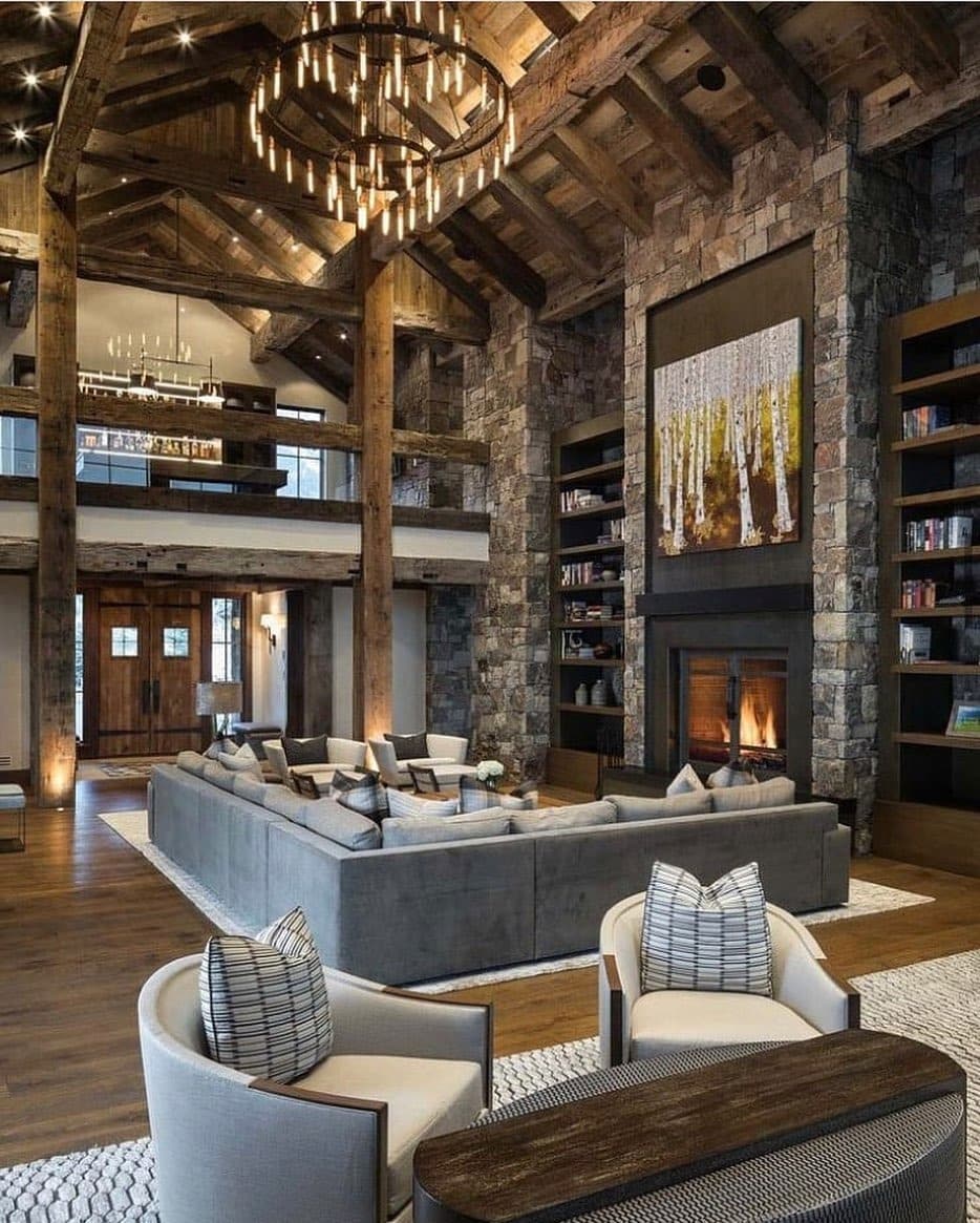 9. Grand Lodge-Style Living Room with Stone Fireplace and Timber Beams - large living room ideas
