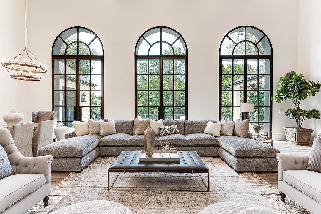 18. Grand Living Room with Arched Windows and Soft Taupe Palette - large living room ideas