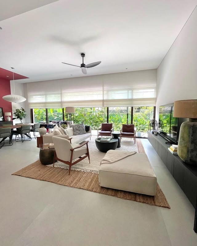20. Indoor-Outdoor Living Room with Neutral Tones and Garden Views - large living room ideas