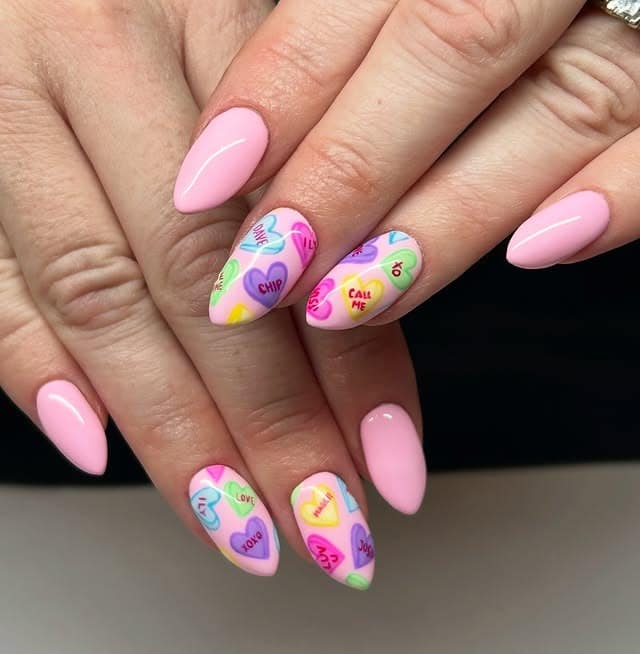 2. Pink Candy Heart Almond Nails with Playful Lettering - nail art ideas