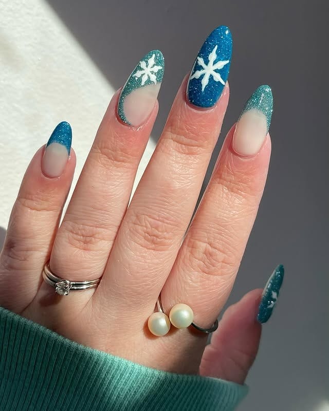 8. Teal Glitter Ombre Almond Nails with Snowflake Art - nail art ideas