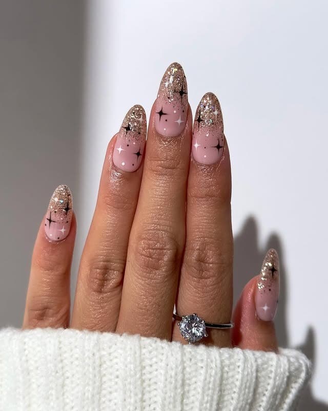 13. Nude Almond Nails with Gold Glitter Fade and Star Accents - nail art ideas