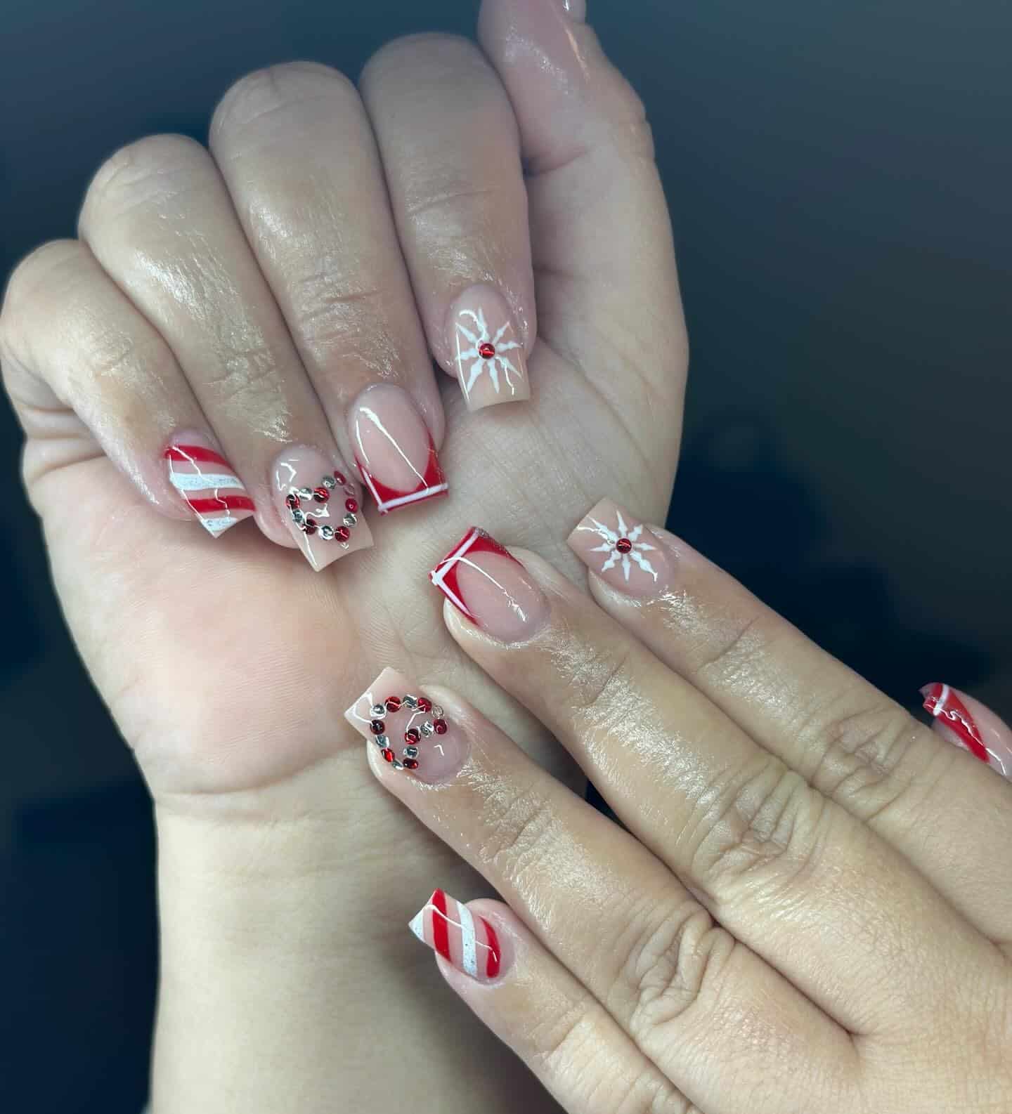 14. Red Candy Cane French Tip Nails with Rhinestone Details - short winter nail ideas