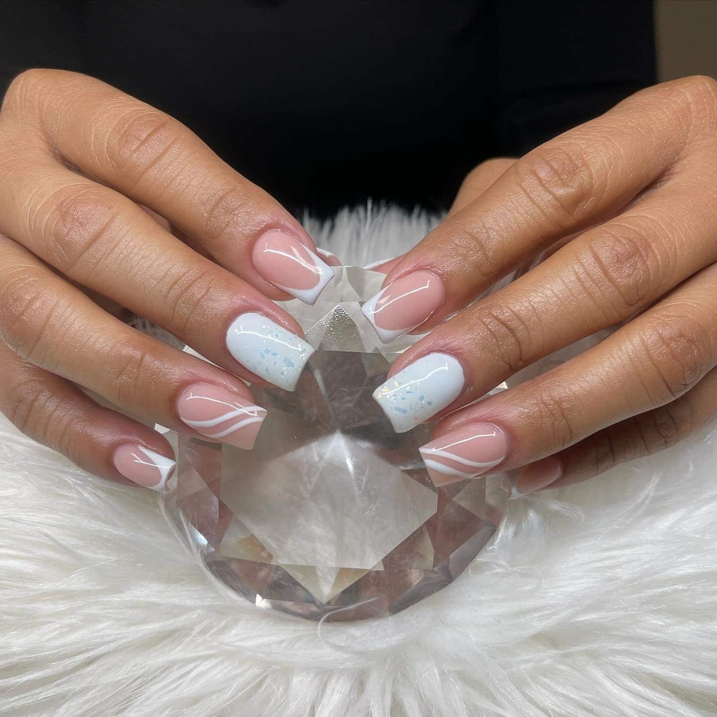 16. Soft Nude and White Swirl French Nails with Icy Accent - short winter nail ideas