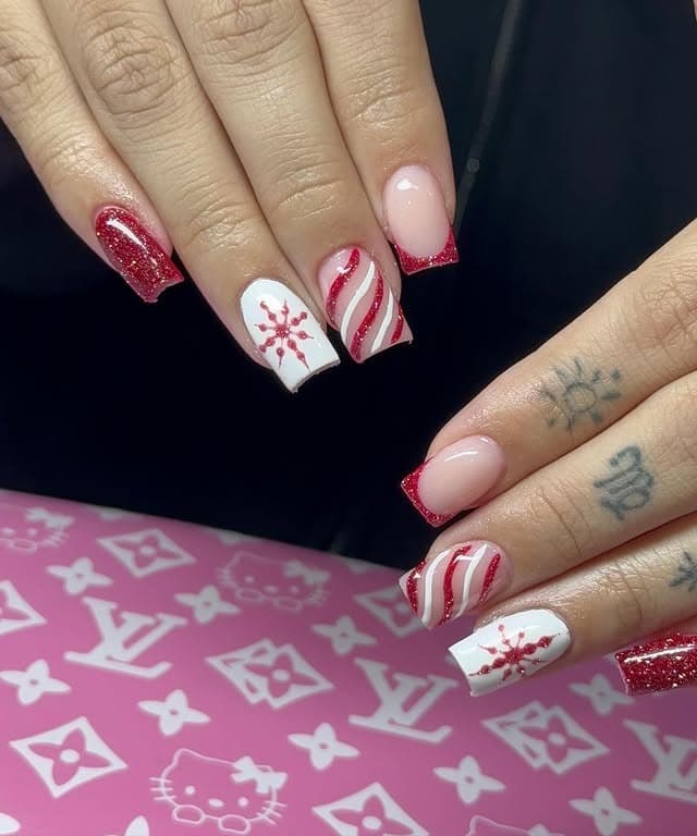 19. Red Glitter and Candy Stripe Winter Nails with Snowflake Accent - short winter nail ideas
