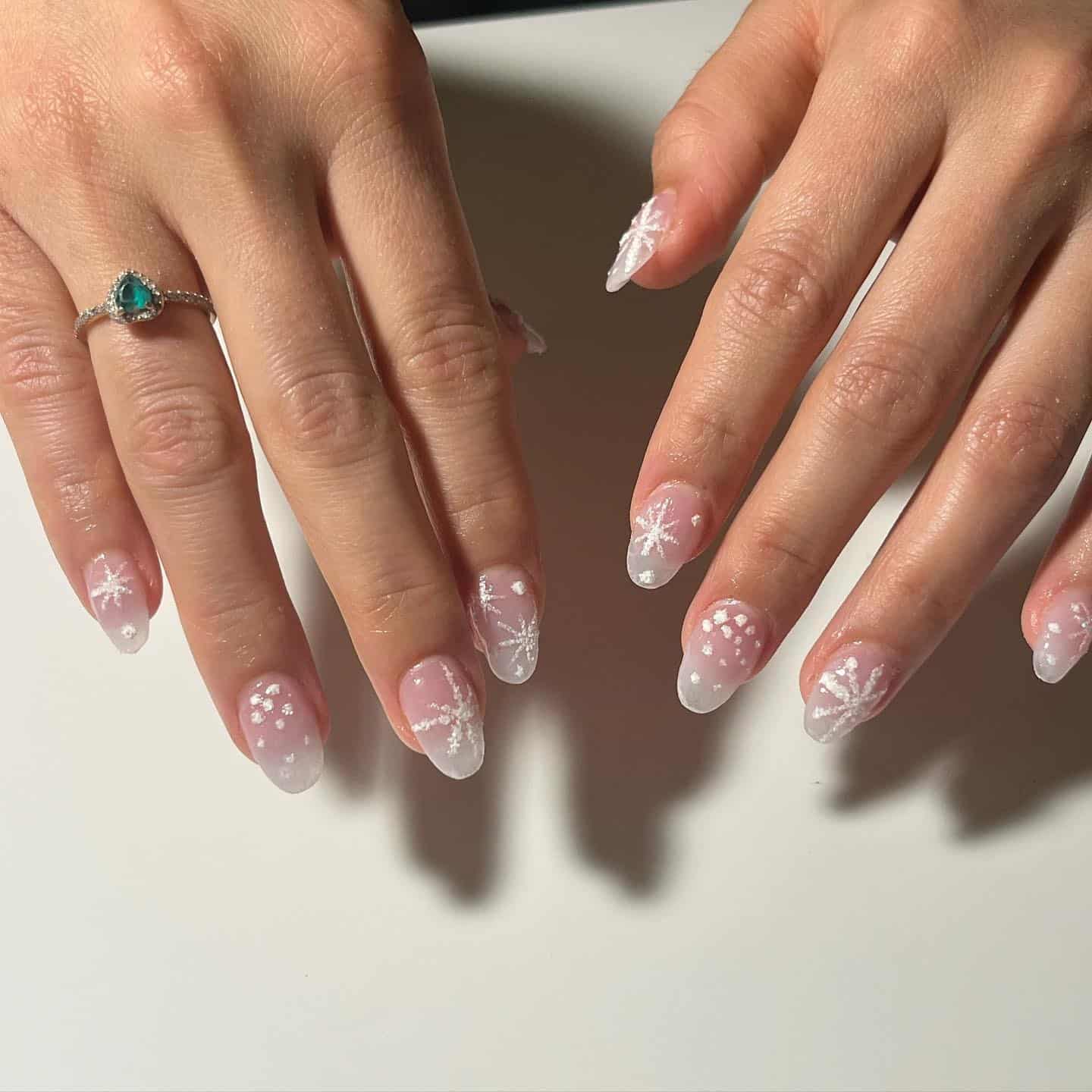 22. Sheer Pink Almond Nails with Frosted Snowflake Art - short winter nail ideas