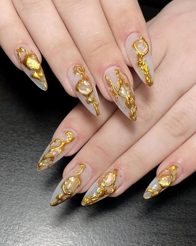1. Molten Gold Stiletto Nails with Nude Base - grunge nail ideas