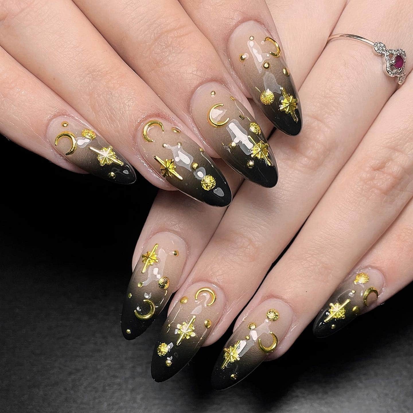 4. Celestial Black Ombre Nails with Gold Charms - grunge nail ideas