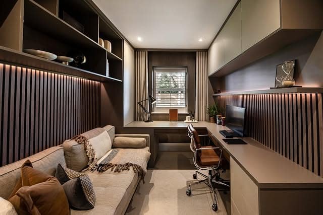 7. Narrow Home Office with Textured Wall Panels and Cozy Seating - home office ideas
