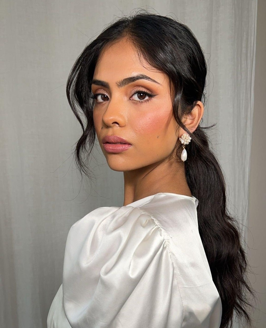 7. Soft Black Low Ponytail with Face-Framing Tendrils - Sleek Low Ponytail