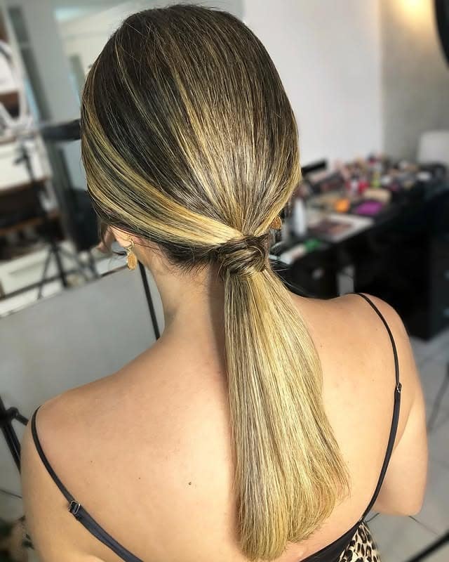 11. Blonde Balayage Sleek Low Ponytail with Wrapped Base - Sleek Low Ponytail