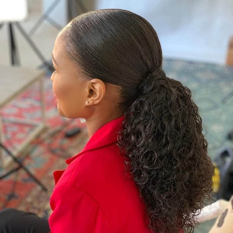 13. Natural Black Sleek Low Ponytail with Defined Curls - Sleek Low Ponytail