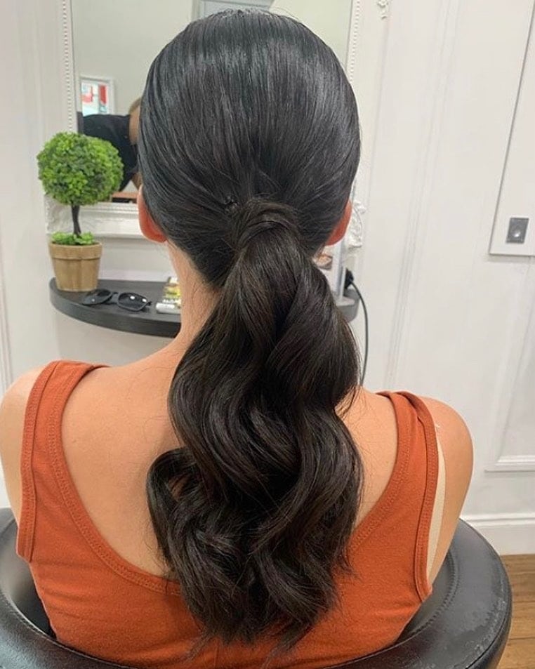 14. Deep Brunette Low Ponytail with Soft Waves - Sleek Low Ponytail