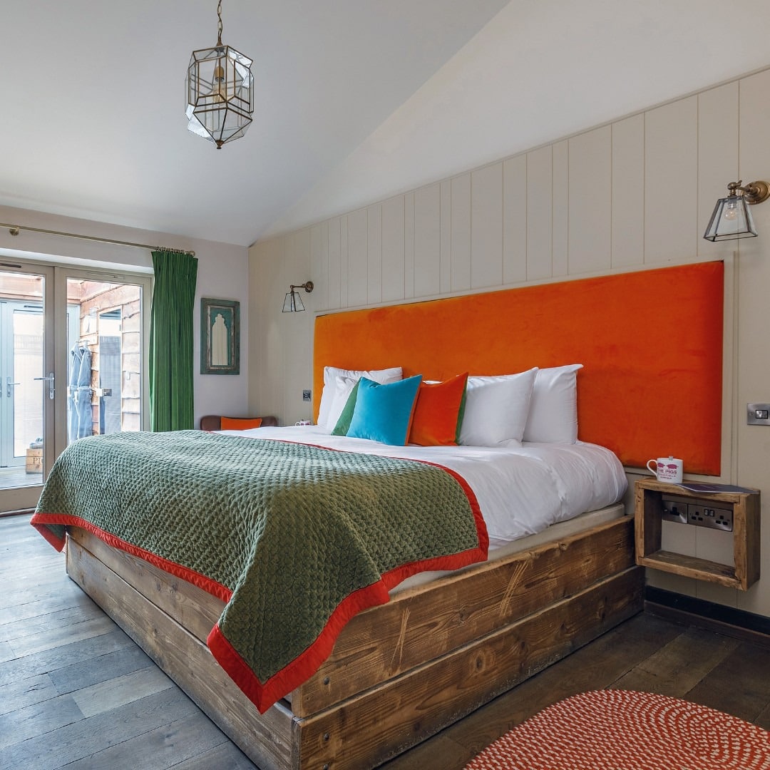 4. Rustic Wood Platform Bedroom with Earthy Tones - spa style bedroom ideas