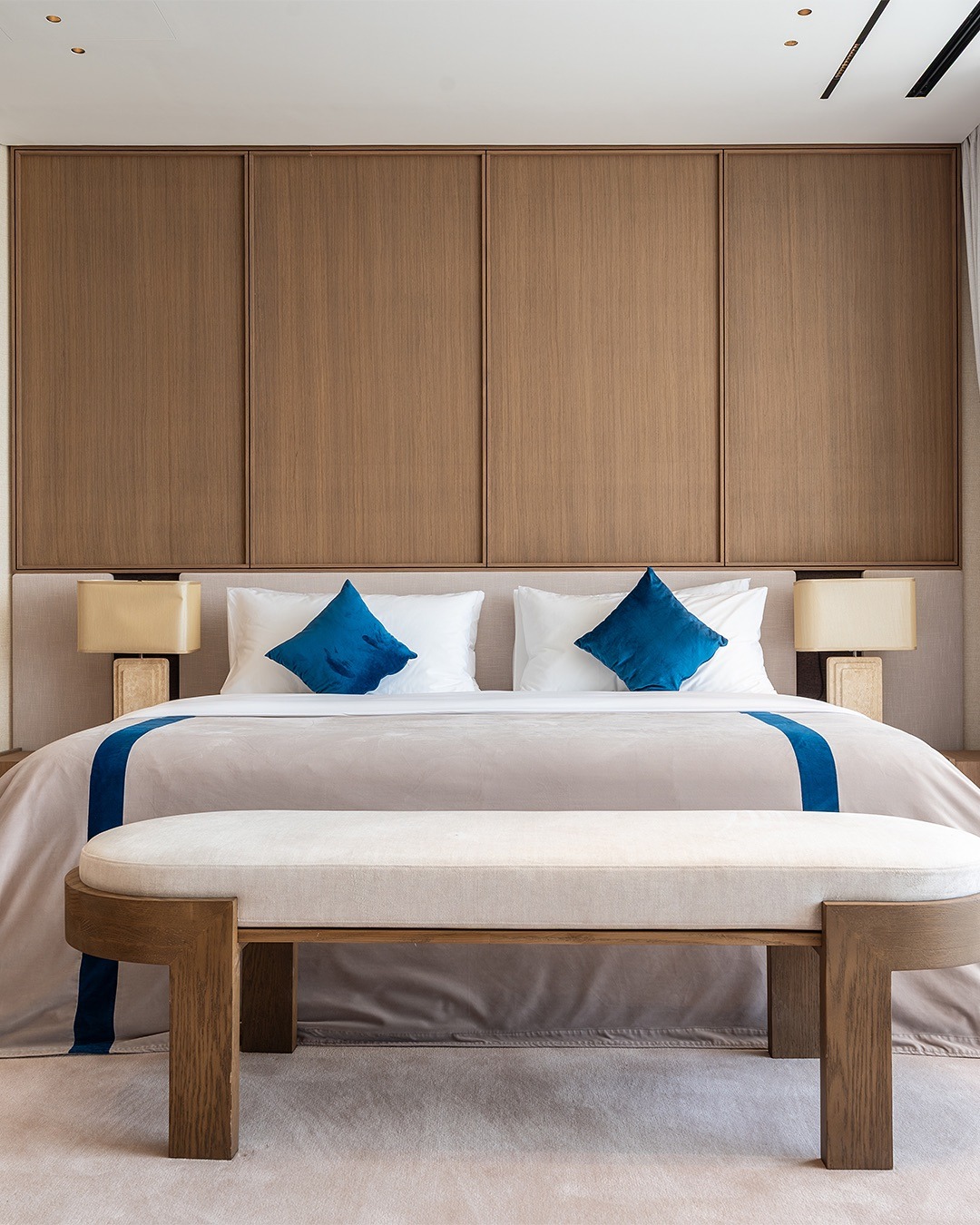 5. Contemporary Wood Panel Bedroom with Blue Accents - spa style bedroom ideas