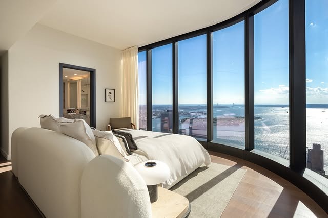15. Modern Curved Window Bedroom with Coastal Views - spa style bedroom ideas