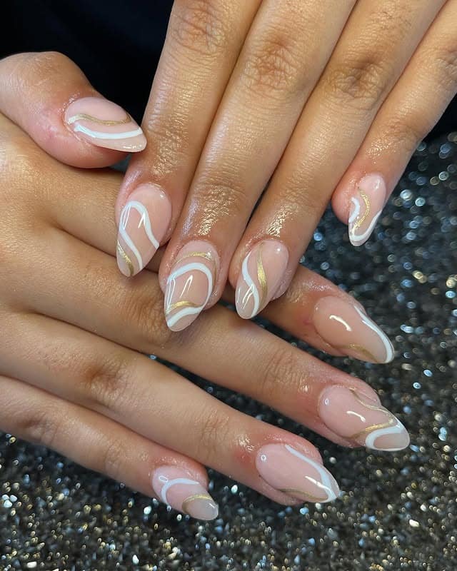 9. Nude Almond Nails with Gold Swirl Accents - nail ideas for wedding