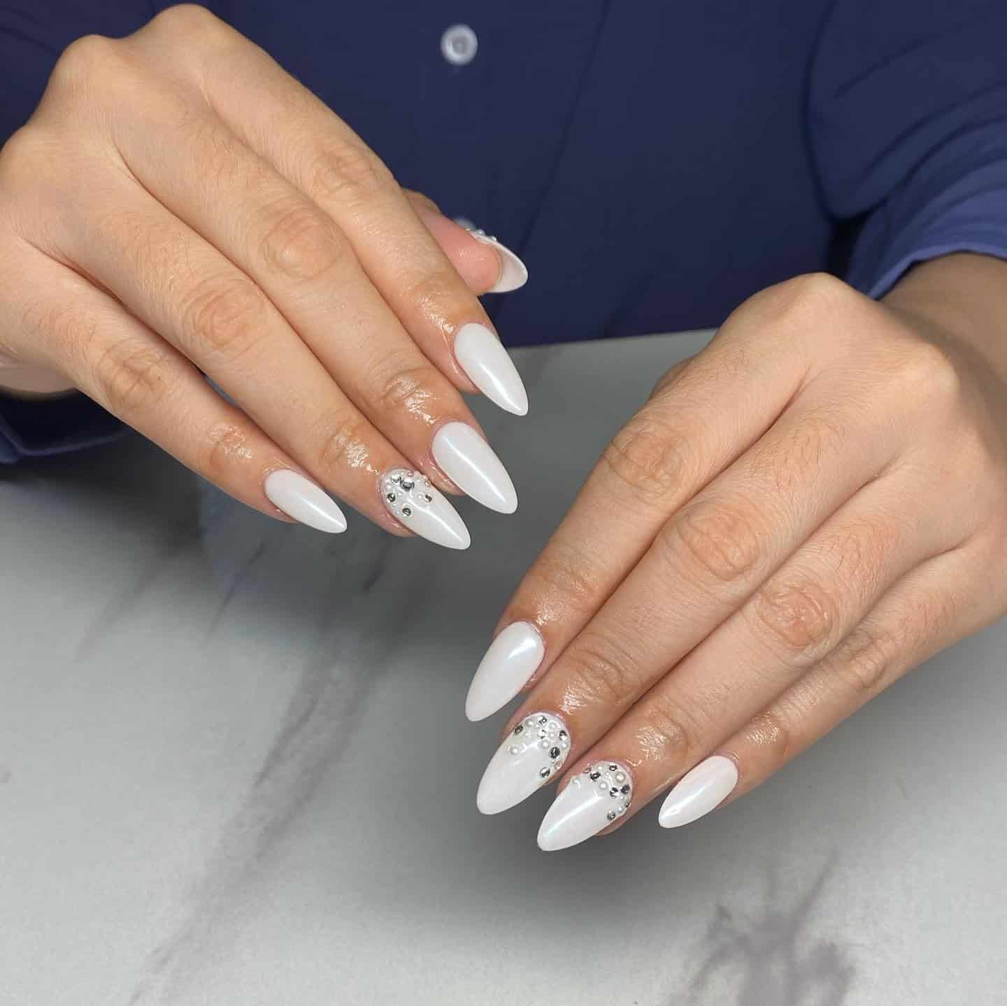 12. Milky White Almond Nails with Crystal Embellishments - nail ideas for wedding